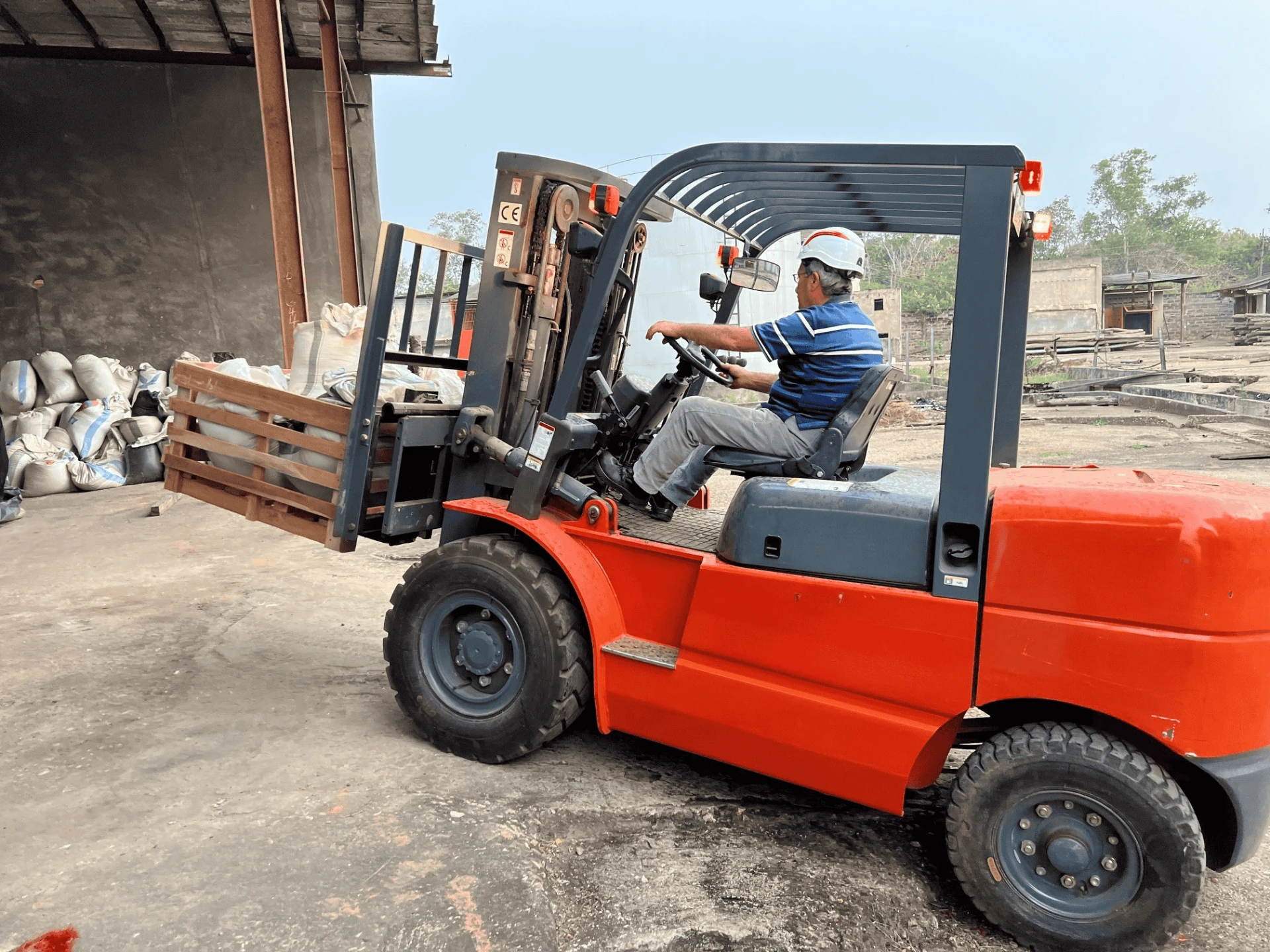 Illustrative image: a forklift handling palletized cargo at a depot