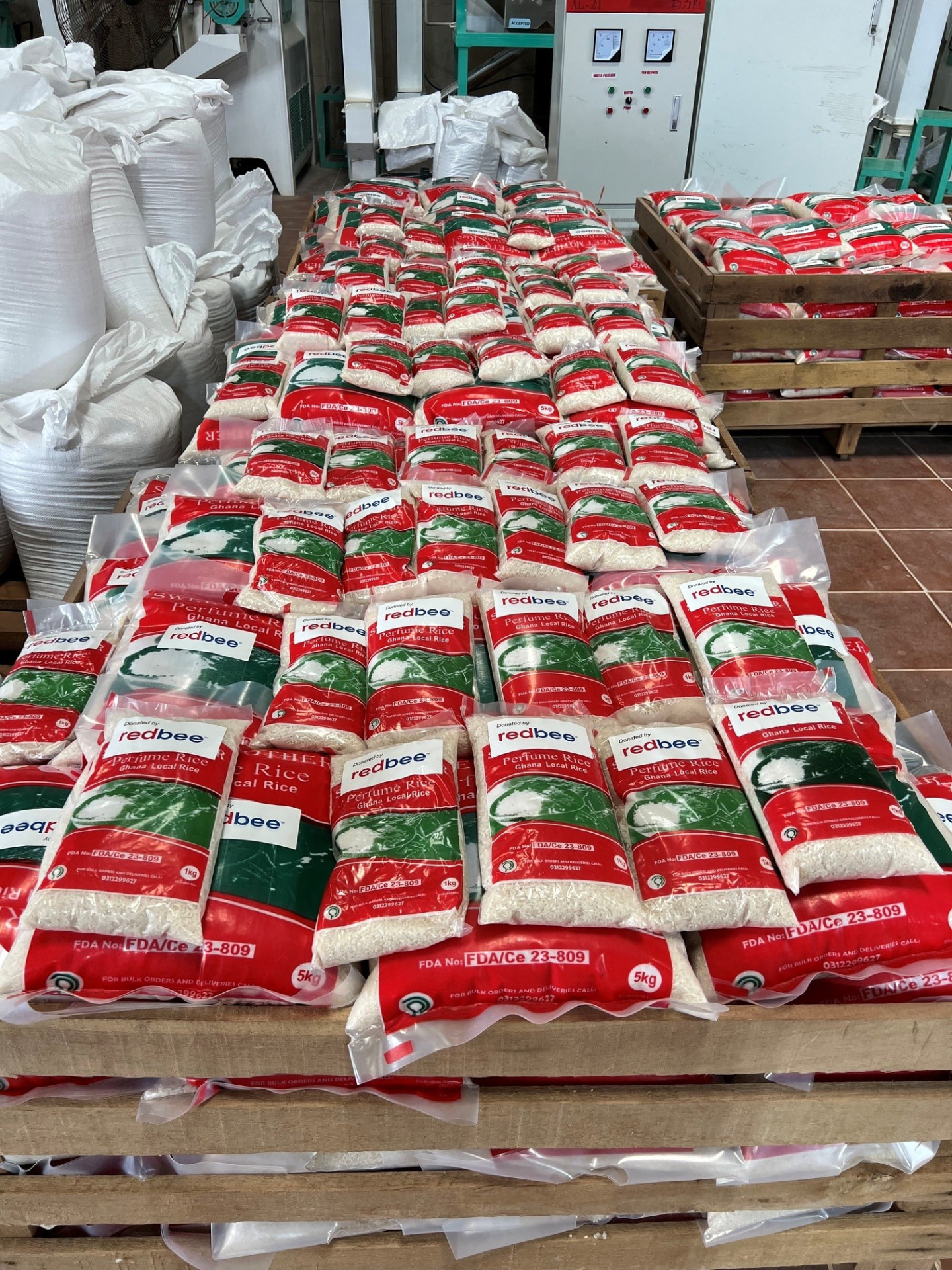 Bags of Ghanaian perfume rice labelled Donated by RedBee, prepared for distribution
