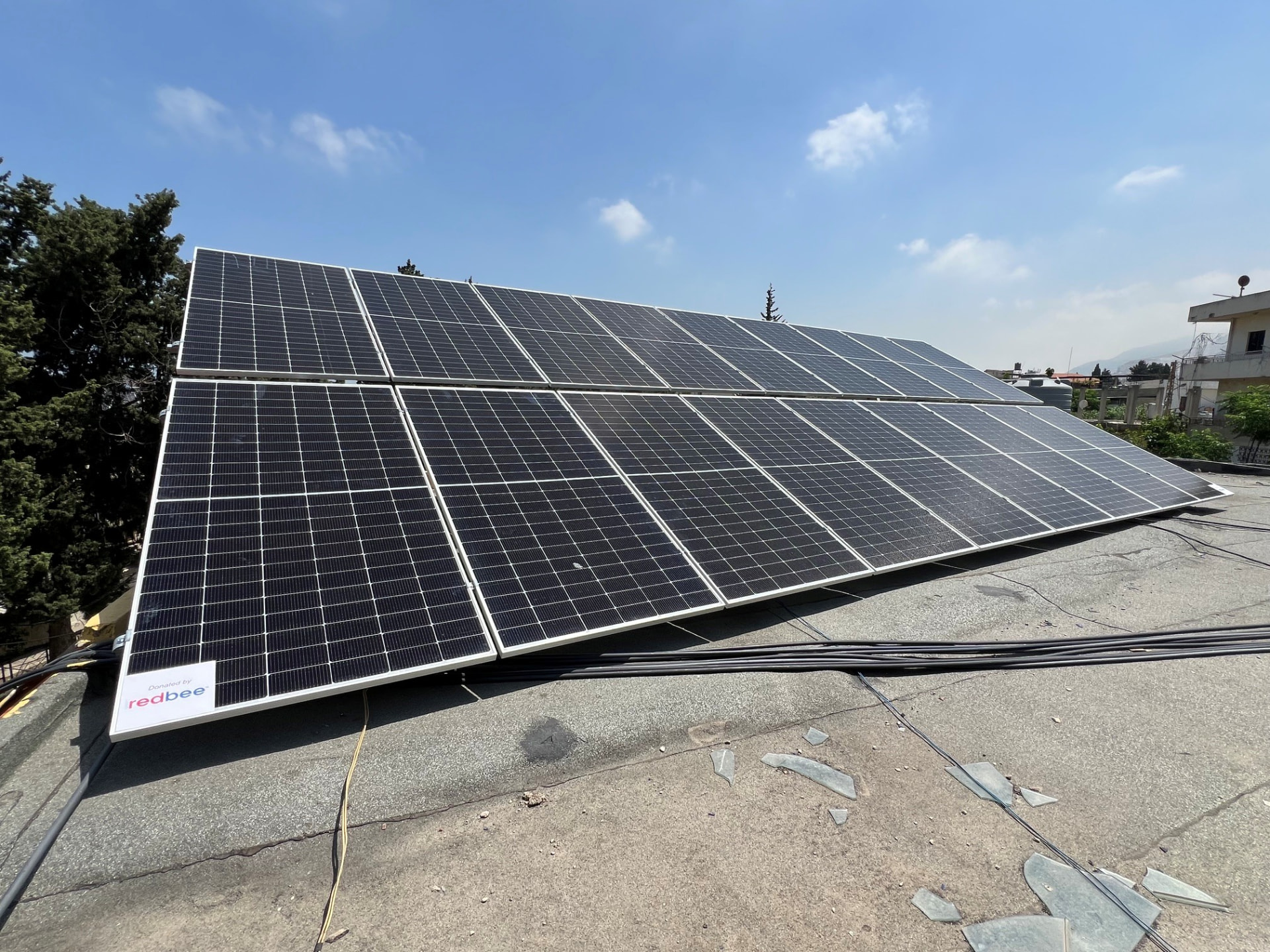 Rooftop solar array marked Donated by RedBee, Lebanon