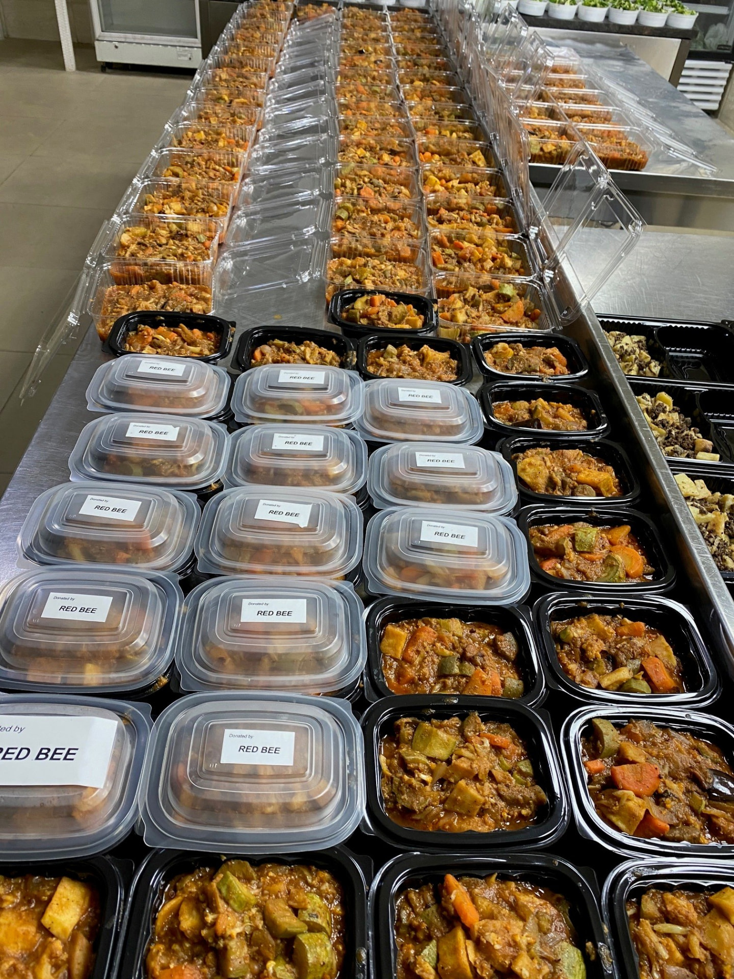 Rows of prepared meal containers labelled Donated by RedBee